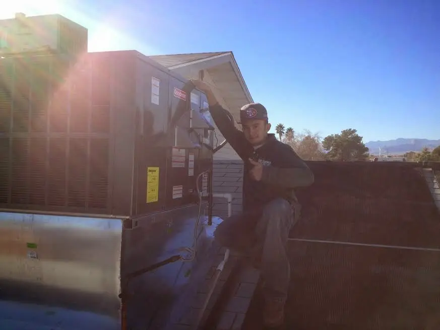 HVAC technician performing HVAC Inspection on a rooftop unit in Black Diamond